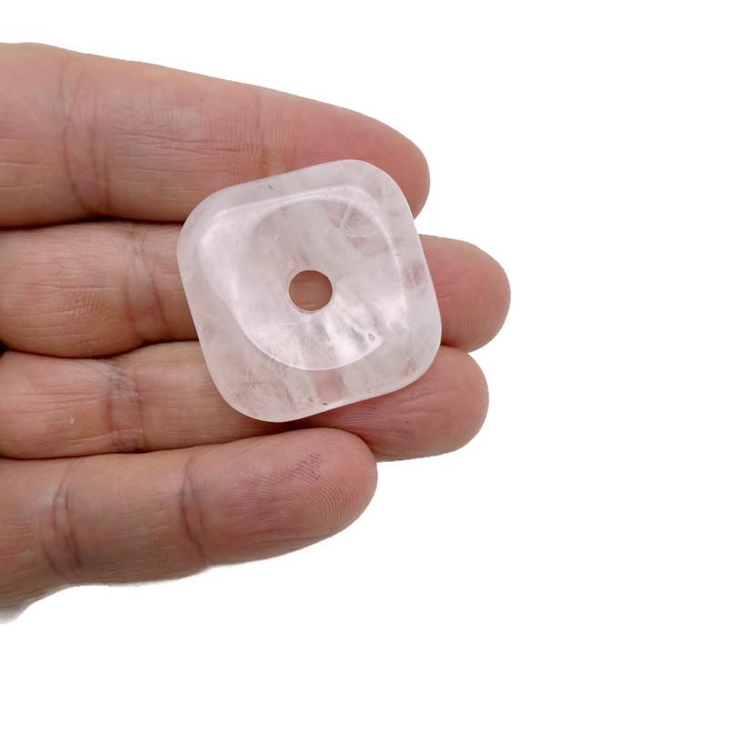 Rose quartz square crystal donut pendant, 30mm Pi stone from GemstoneGO, showcasing a polished pink gemstone with a hole in the center.