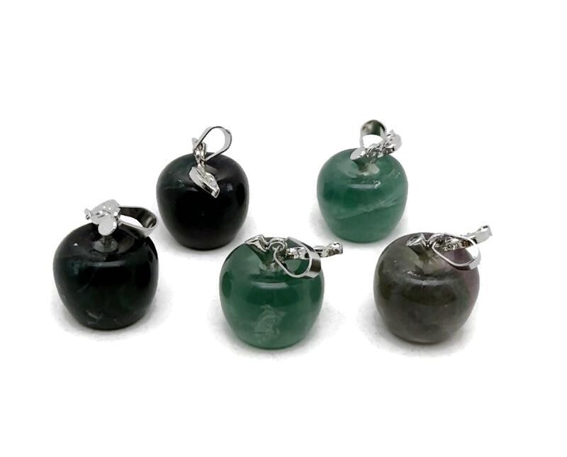 Mini fluorite apple crystal pendant from GemstoneGO, featuring a vibrant green and purple gemstone carved into an apple shape.