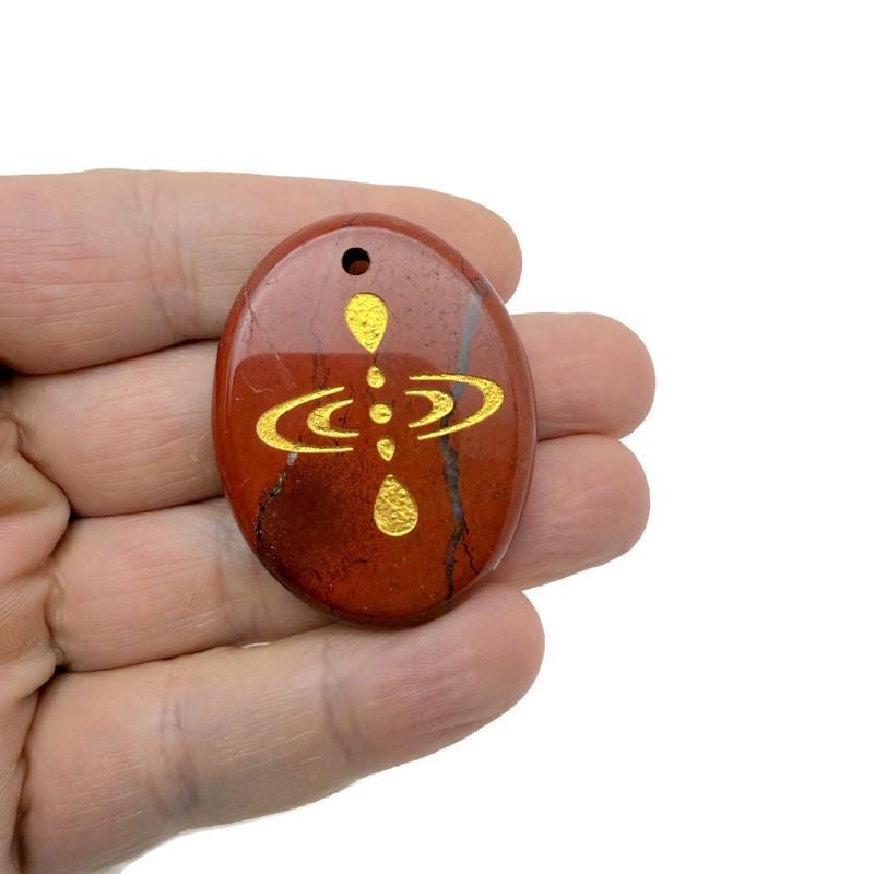 Drilled cosmic energy symbol engraved crystal amulet by GemstoneGO, featuring universe alignment and spiritual gemstone design.