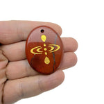 Drilled cosmic energy symbol engraved crystal amulet by GemstoneGO, featuring universe alignment and spiritual gemstone design.