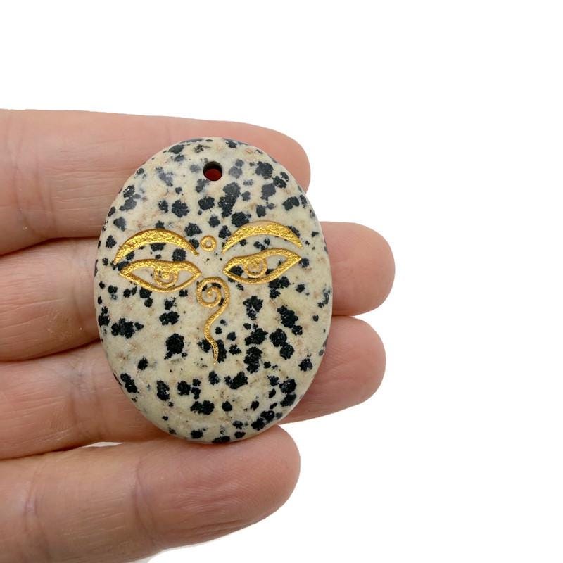 Crystal amulet with engraved Buddha eyes, drilled for spiritual insight and guidance by GemstoneGO.