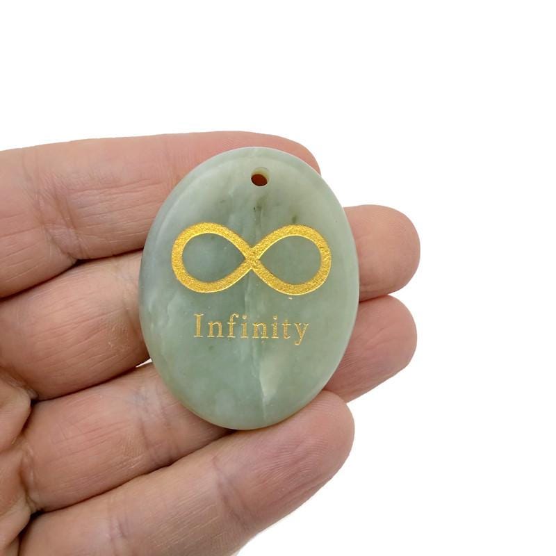 Drilled infinity loop engraved crystal pendant symbolizing endless love and protection, showcasing a clear gemstone by GemstoneGO.