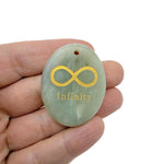 Drilled infinity loop engraved crystal pendant symbolizing endless love and protection, showcasing a clear gemstone by GemstoneGO.