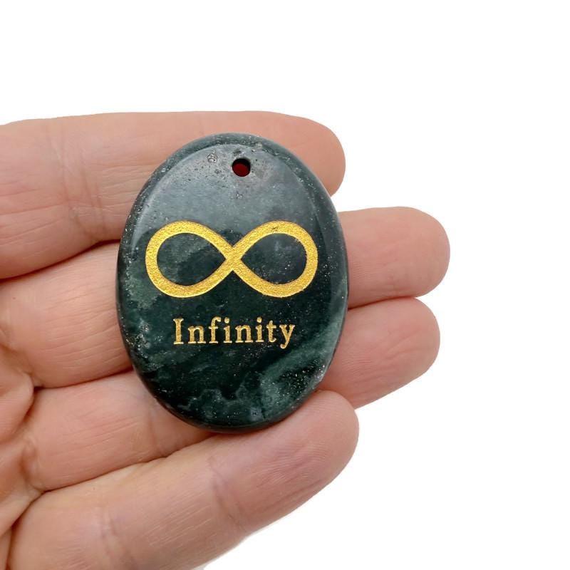 Engraved crystal infinity loop pendant with drilled symbol of endless love and protection by GemstoneGO.