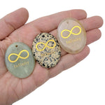 Engraved crystal infinity loop symbol of endless love and protection by GemstoneGO, drilled for hanging or jewelry.