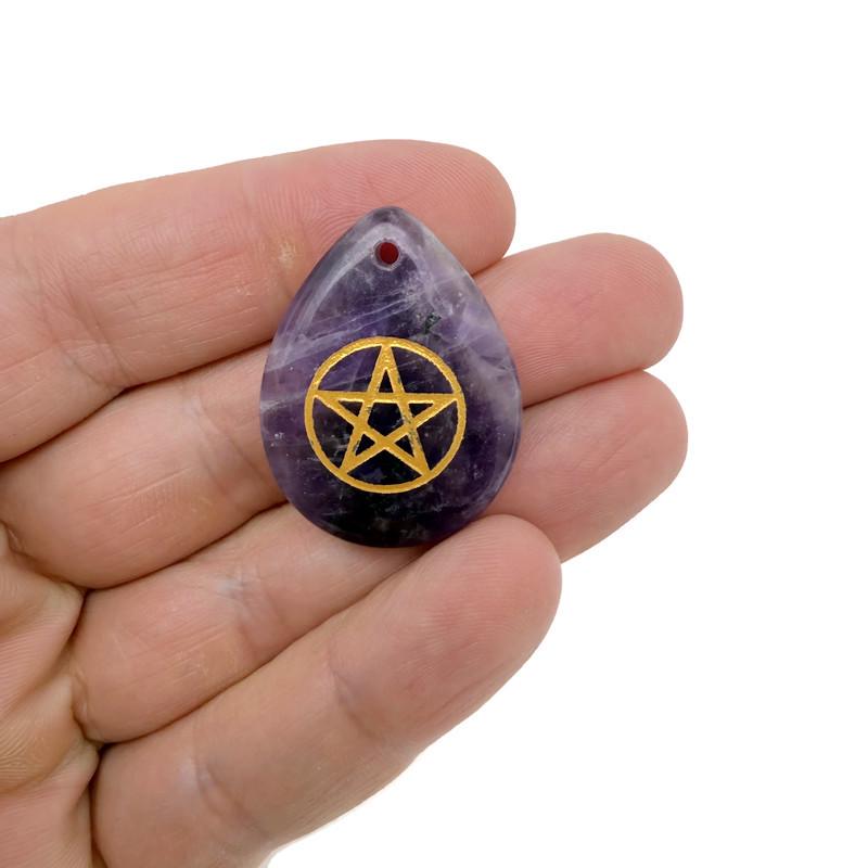 Pentagram engraved crystal from GemstoneGO, drilled for Pagan protection and balance, with intricate gemstone details.
