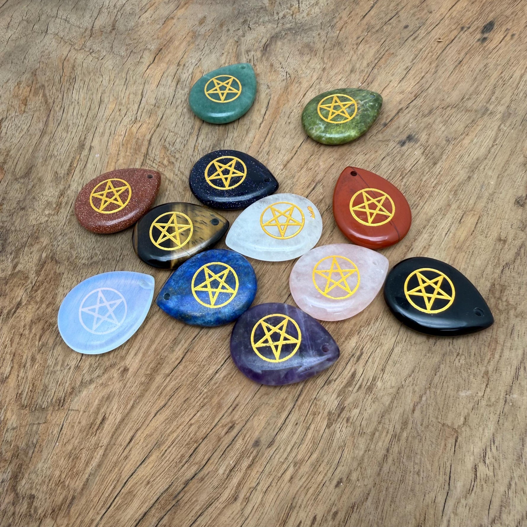 Pentagram engraved crystal from GemstoneGO featuring drilled holes, used for pagan protection and spiritual balance.