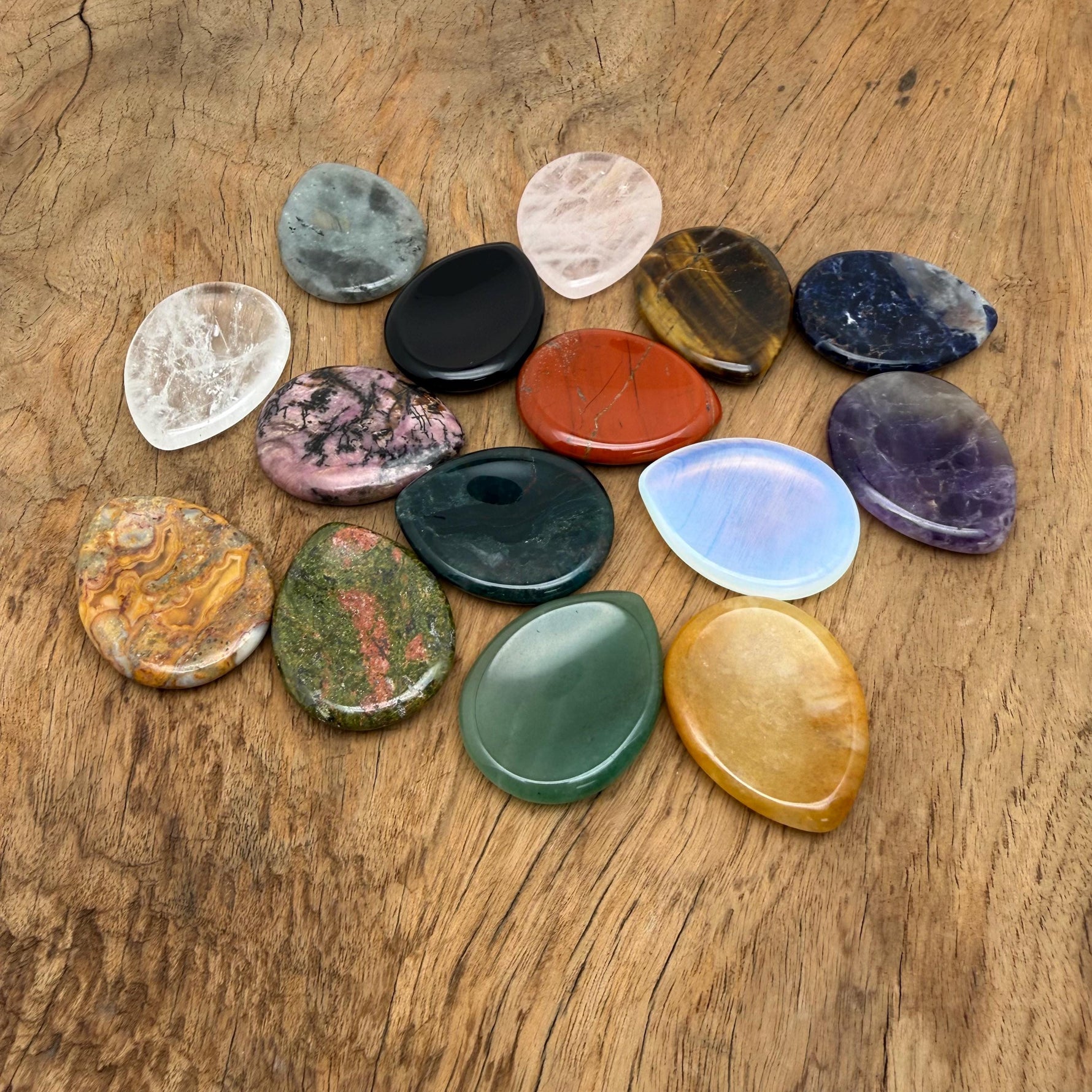 Teardrop-shaped natural worry stone from GemstoneGO with soothing crystal gemstone, measuring 4.5x3.5cm, relaxing and calming.
