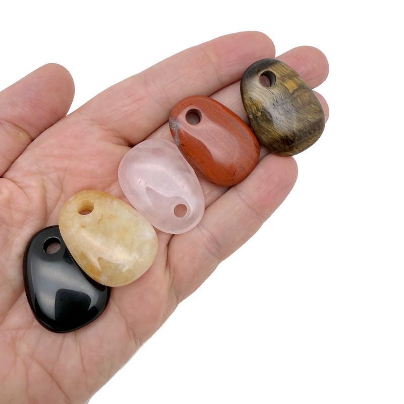Oval crystal pendant from GemstoneGO, natural stone jewelry making bead in a mix of colors and textures.