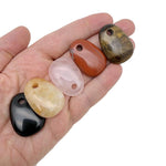 Oval crystal pendant from GemstoneGO, natural stone jewelry making bead in a mix of colors and textures.