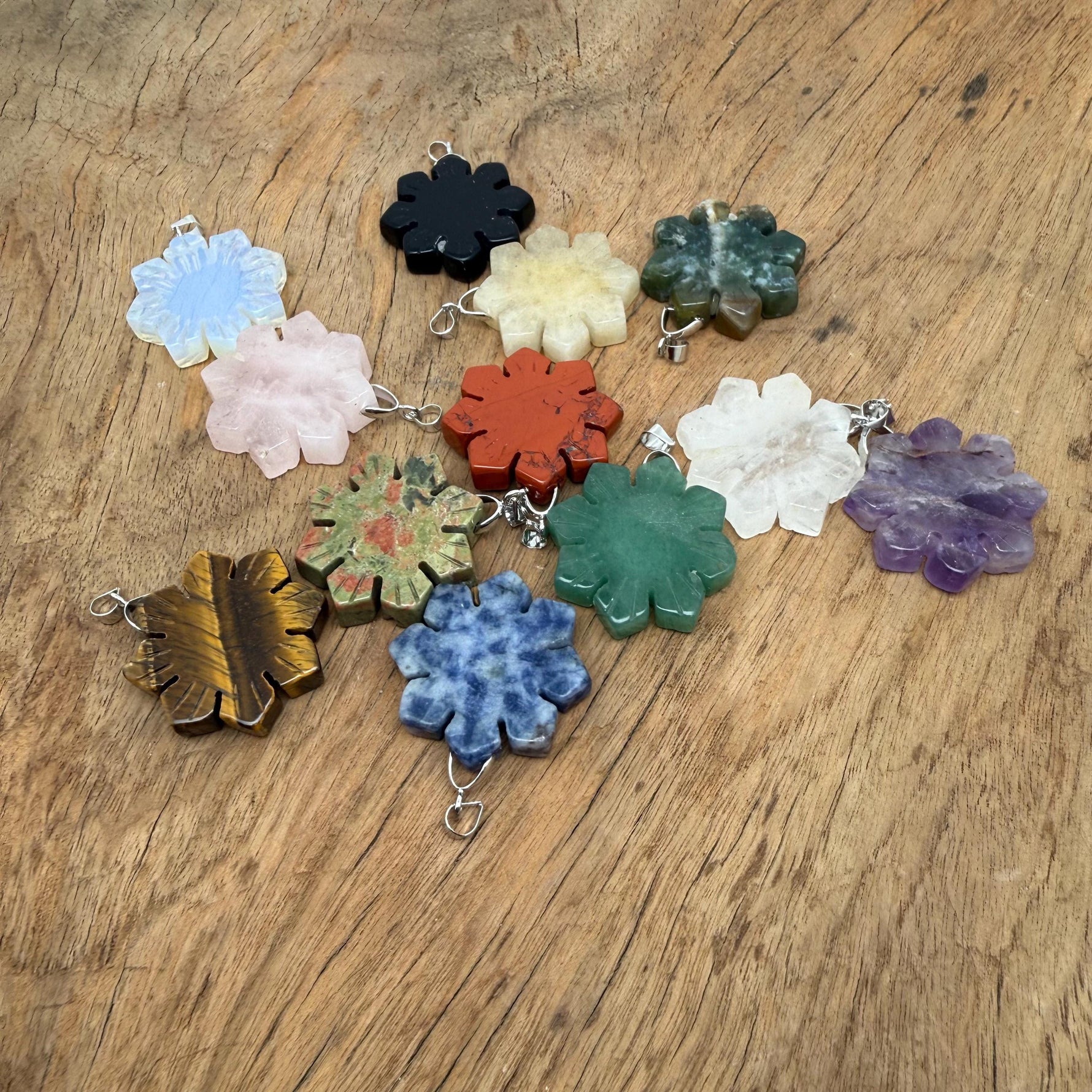 Snowflake gemstone pendant with healing stones from GemstoneGO, featuring a delicate design and mixed gemstone colors.