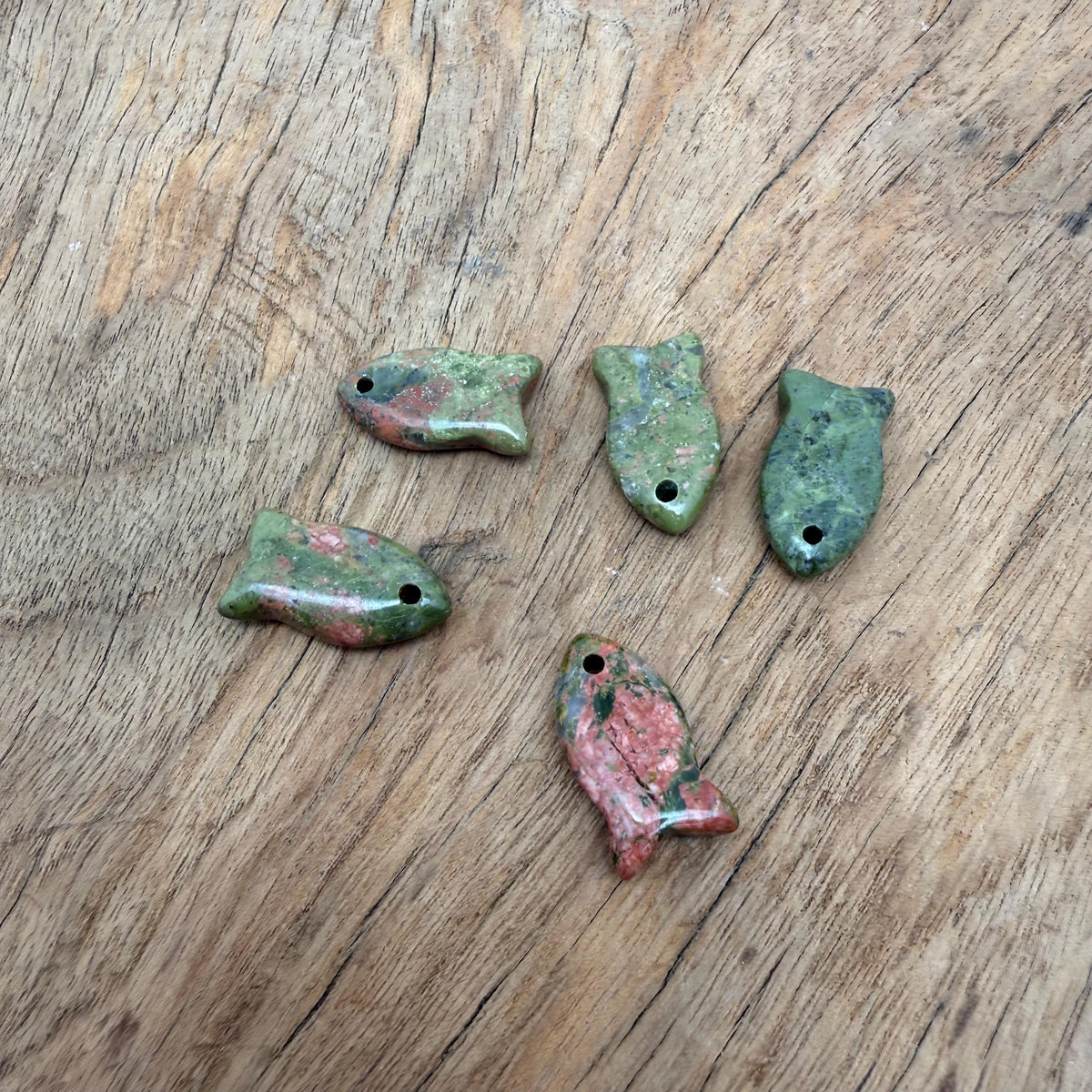 Unakite fish-shaped crystal pendant with healing stone, featuring vibrant green and pink hues, jewelry charm by GemstoneGO.