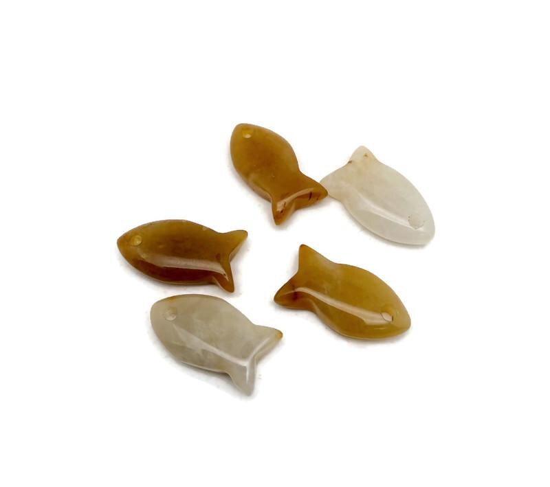 Yellow jade fish-shaped crystal pendant with healing stone charm, featuring a vibrant fish design for jewelry.