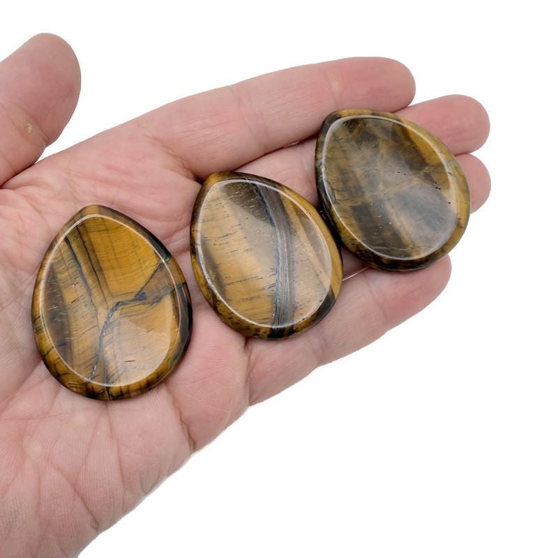 Polished Tiger Eye worry stone from GemstoneGO, 45mm, smooth, oval-shaped calming crystal for stress relief and meditation.