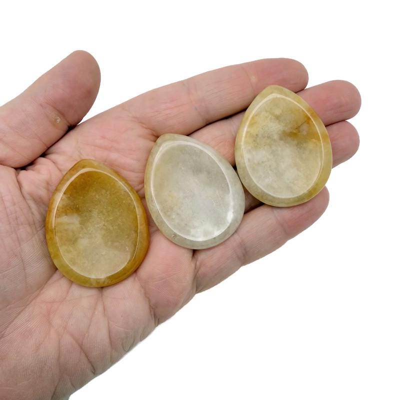 Yellow jade worry stone from GemstoneGO, smooth 45mm crystal for stress relief and calming touch.