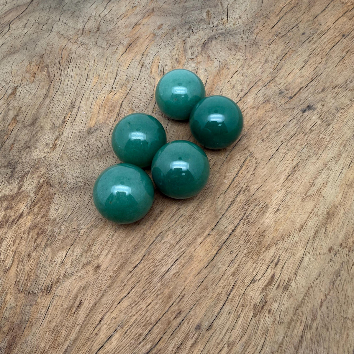 A 25mm Aventurine sphere gemstone with a smooth polished surface, showcasing its vibrant green color and natural gemstone features.