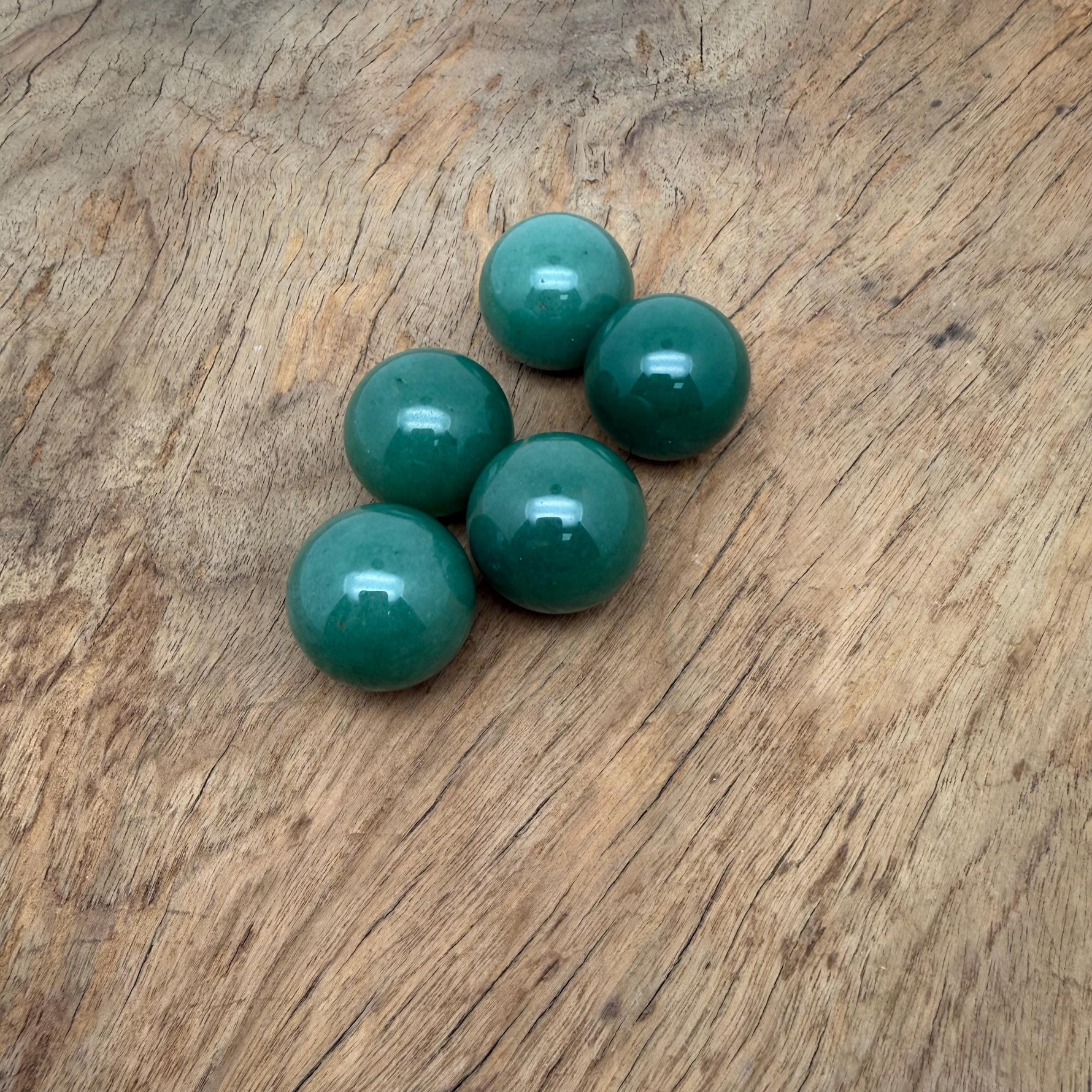 A 25mm Aventurine sphere gemstone with a smooth polished surface, showcasing its vibrant green color and natural gemstone features.