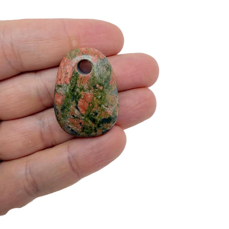 Unakite oval crystal pendant from GemstoneGO featuring a natural stone bead for jewelry making, shown in close-up detail.