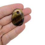 Oval Tiger Eye crystal pendant from GemstoneGO, showcasing natural stone jewelry making bead with rich golden-brown hues.