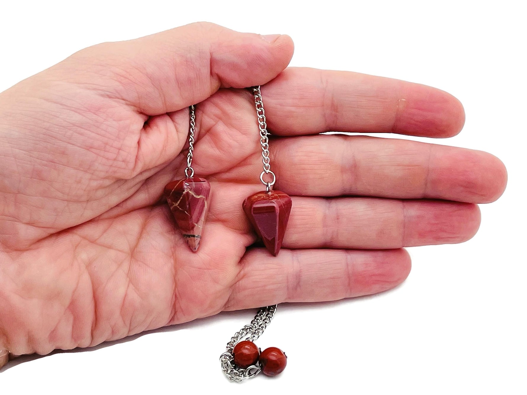 Healing crystal pendulum with stainless steel chain from GemstoneGO, featuring a polished gemstone and intricate chain design.