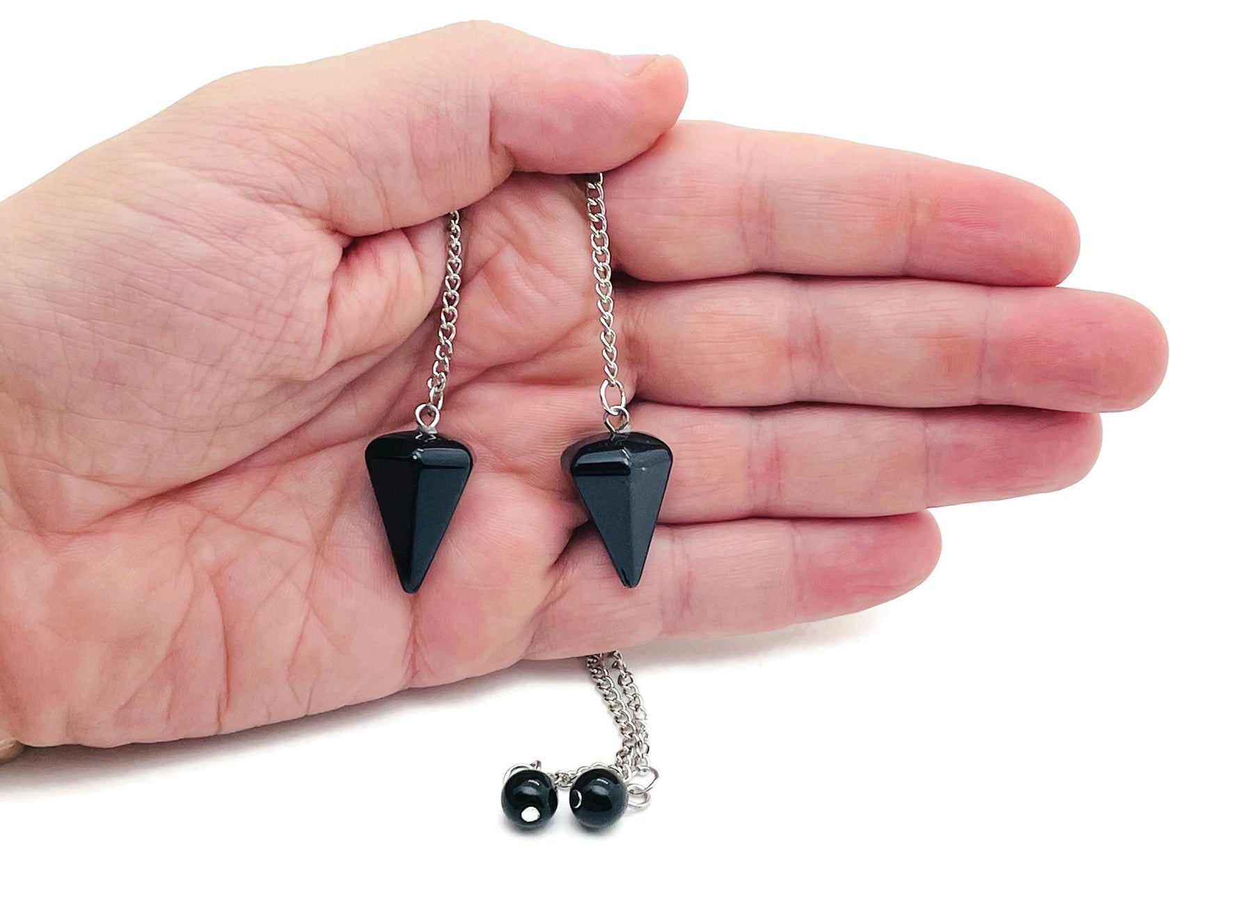 Healing crystal pendulum with stainless steel chain from GemstoneGO, featuring a clear, polished gemstone for spiritual guidance.