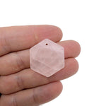 Faceted rose quartz hexagon crystal pendant on a necklace, showcasing a pink gemstone bead from GemstoneGO.