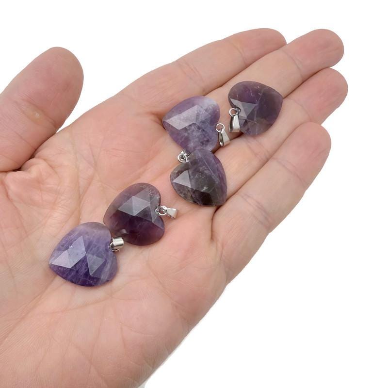 Faceted amethyst heart crystal pendant from GemstoneGO, showcasing a natural purple gemstone charm with detailed facets.