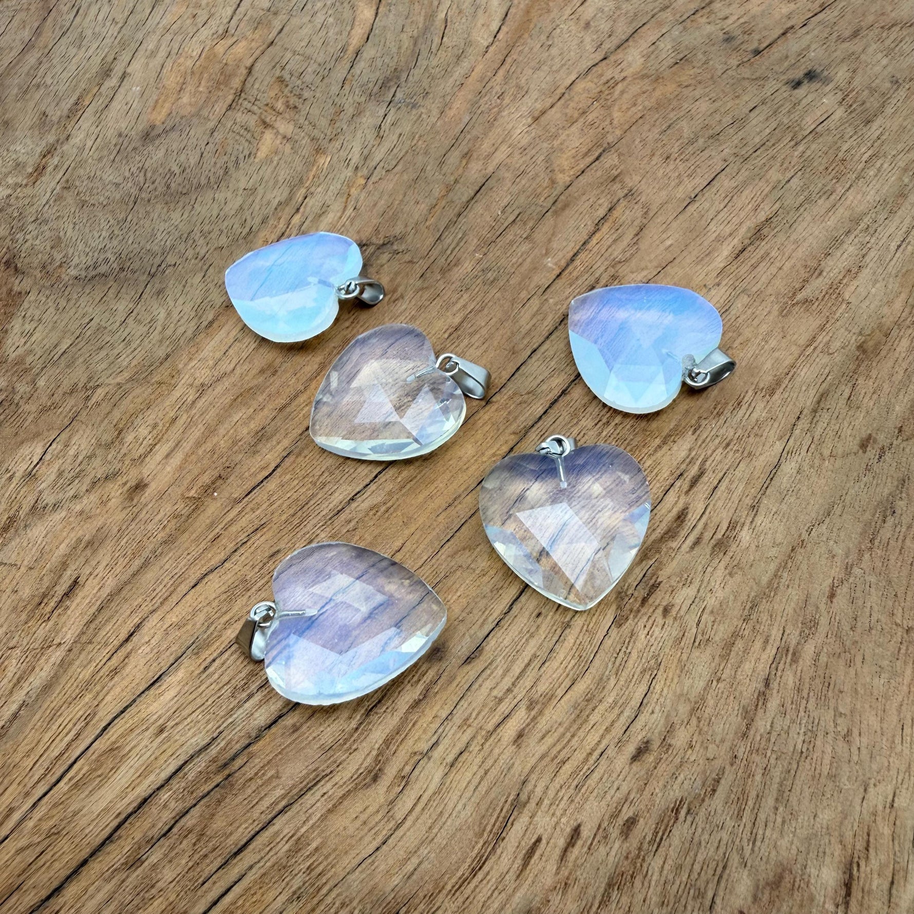 Opalite faceted heart crystal pendant from GemstoneGO showcasing a shimmering natural crystal charm on a silver chain.