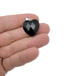 Faceted obsidian heart crystal pendant from GemstoneGO, natural black gemstone charm with a polished, shiny surface.