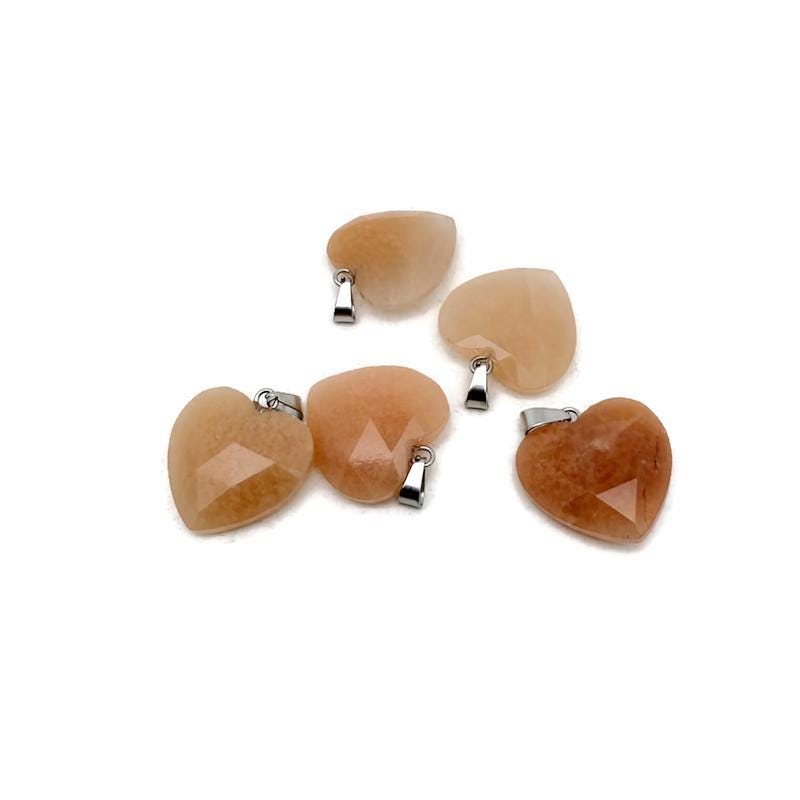 Faceted orange aventurine heart-shaped crystal pendant with natural gemstone charm, showcasing its vibrant orange color and polished surface.