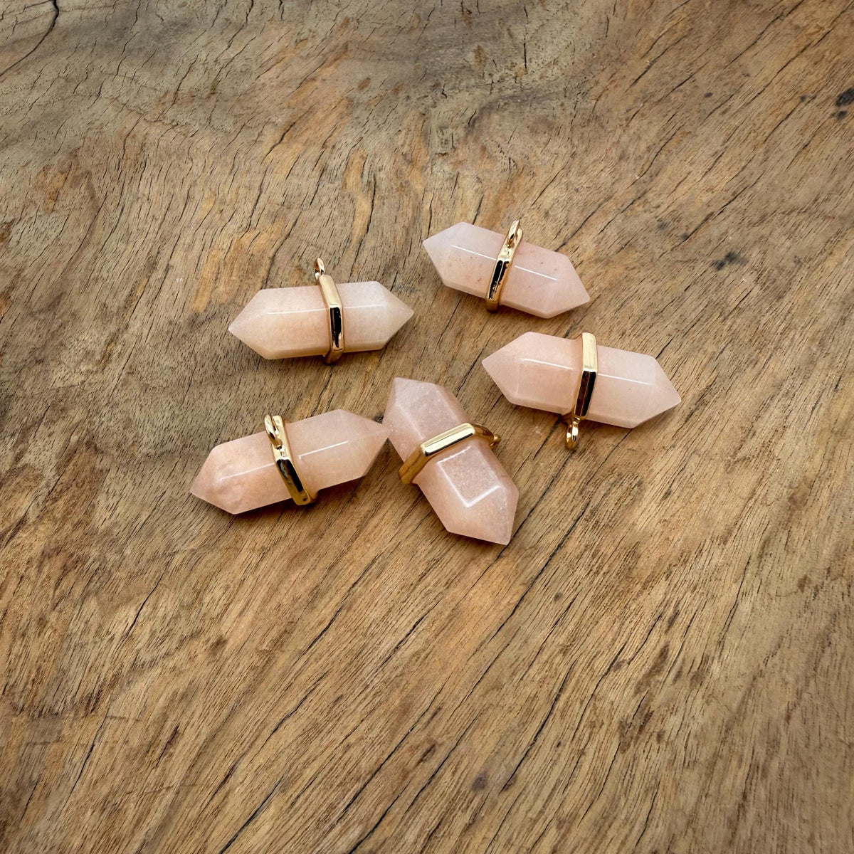 Orange aventurine double terminated crystal pendant with natural gemstone points, showcasing vibrant orange color and polished surface.