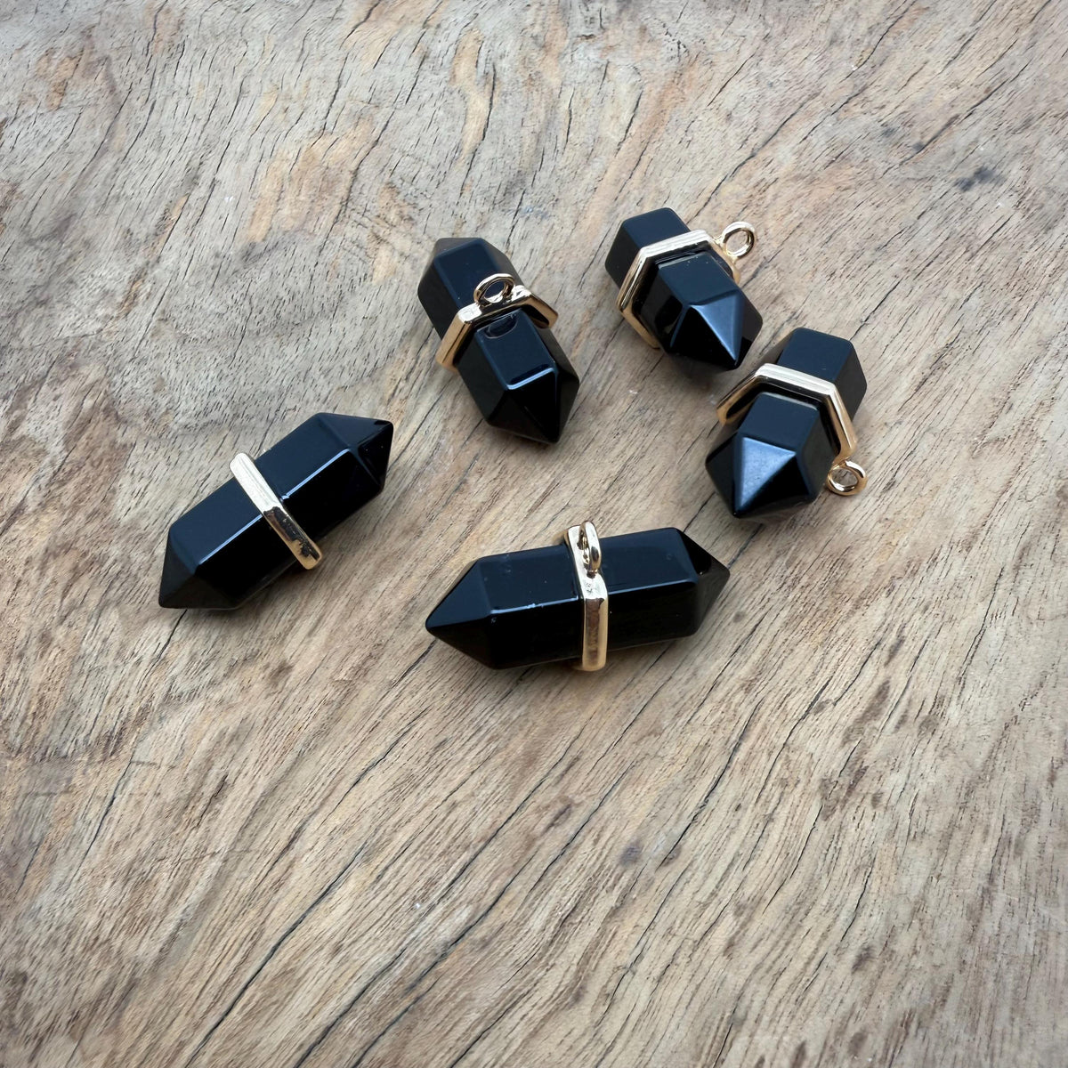 Natural obsidian double terminated crystal pendant from GemstoneGO, featuring a sleek gemstone point with polished surfaces.