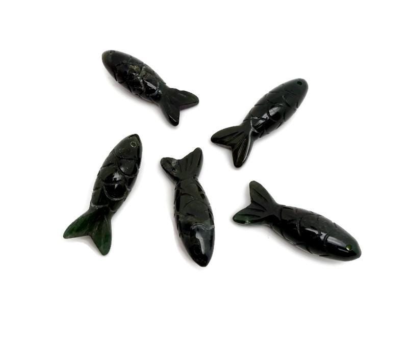 Moss agate fish gemstone pendant, a natural lucky fishing charm with intricate green and brown patterns, from GemstoneGO.