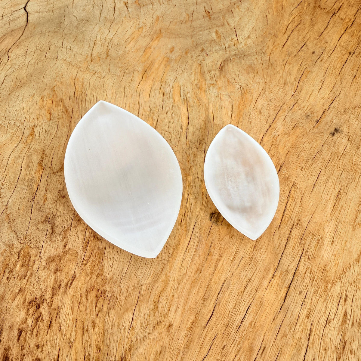 Polished selenite leaf-shaped gemstone plate with carved details, ideal for home decor and display.