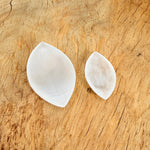 Polished selenite leaf-shaped gemstone plate with carved details, ideal for home decor and display.