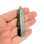 Pyrite obelisk tower crystal from GemstoneGO, showcasing a shiny, gold-toned mineral with sharp, geometric edges.
