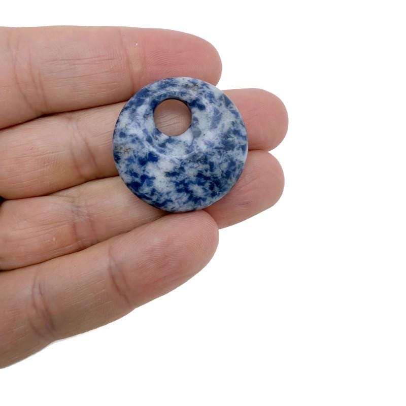 Polished crystal donut pendant from GemstoneGO, 30mm Pi Stone healing crystal component in mixed colors, smooth and polished surface.