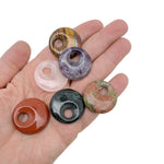 Polished 30mm crystal donut from GemstoneGO featuring a Pi stone design, used as a healing crystal component, in mixed colors.