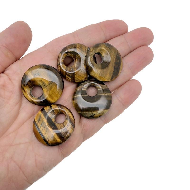 Tiger Eye crystal donut pendant, 30mm Pi Stone by GemstoneGO, showcasing the polished, golden-brown gemstone with distinctive chatoyancy.
