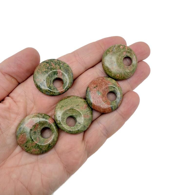 Unakite crystal donut pendant from GemstoneGO, 30mm Pi Stone with vibrant green and pink mineral patterns.