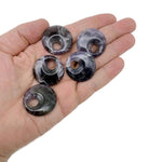 Amethyst crystal donut pendant from GemstoneGO, 30mm Pi stone with purple gemstone and polished finish, showcasing a smooth, rounded shape.