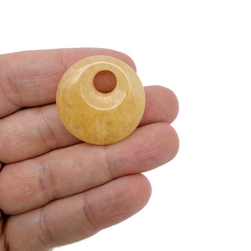 Yellow Jade crystal donut pendant from GemstoneGO, 30mm Pi Stone with polished yellow jade surface and detailed donut shape.