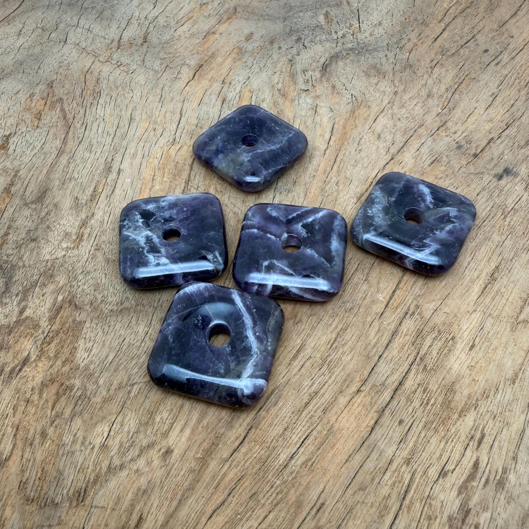 Square amethyst crystal donut pendant from GemstoneGO, 30mm Pi Stone with vibrant purple hues and polished gemstone finish.