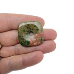 Unakite square crystal donut pendant, 30mm Pi stone by GemstoneGO, showing vibrant green and pink unakite mineral patterns.