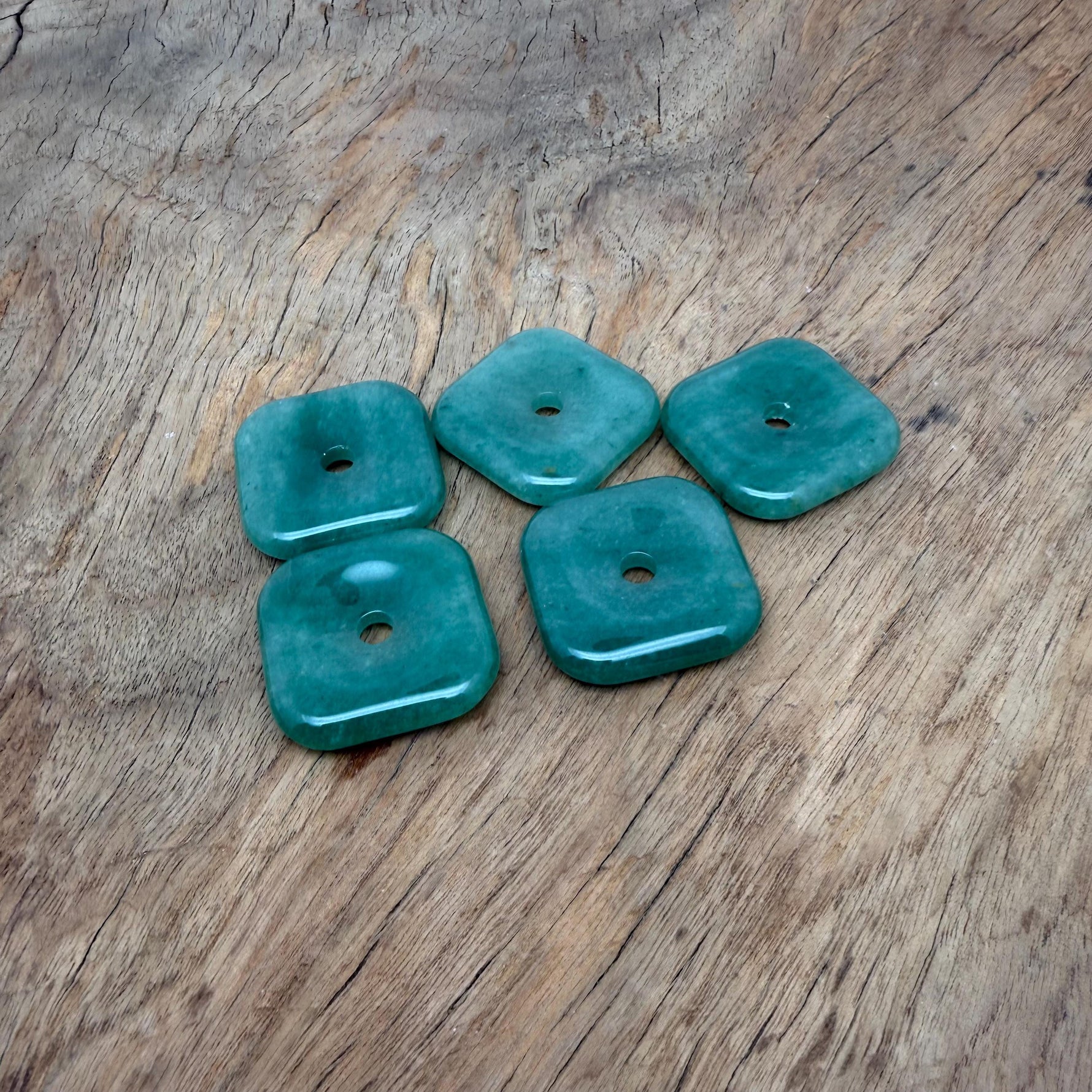 A 30mm aventurine square crystal donut from GemstoneGO with a polished green gemstone appearance and smooth, rounded edges.