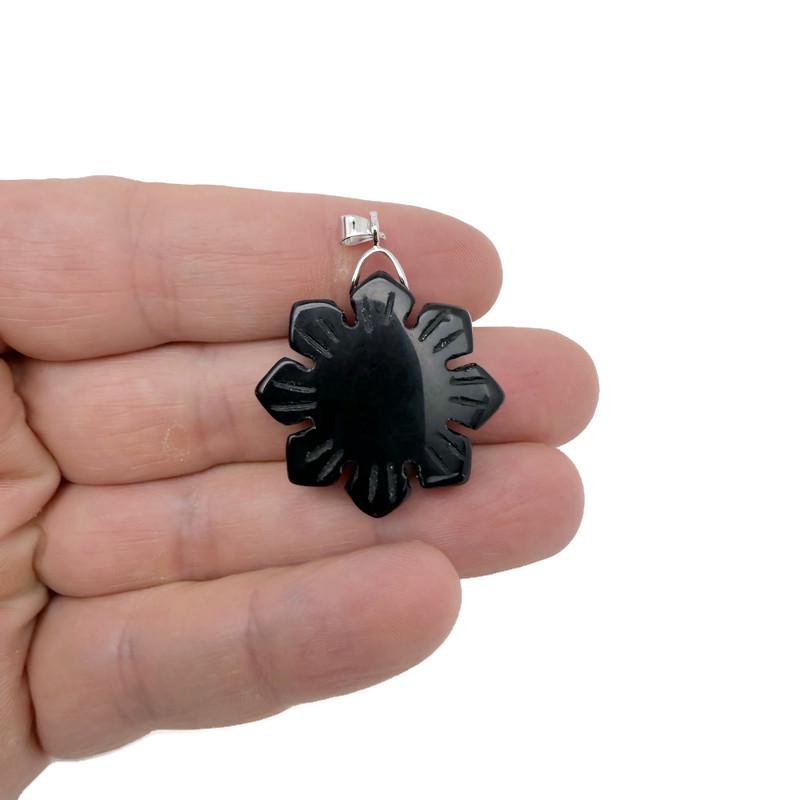 Snowflake gemstone pendant by GemstoneGO featuring a healing stone with intricate design on a silver chain.