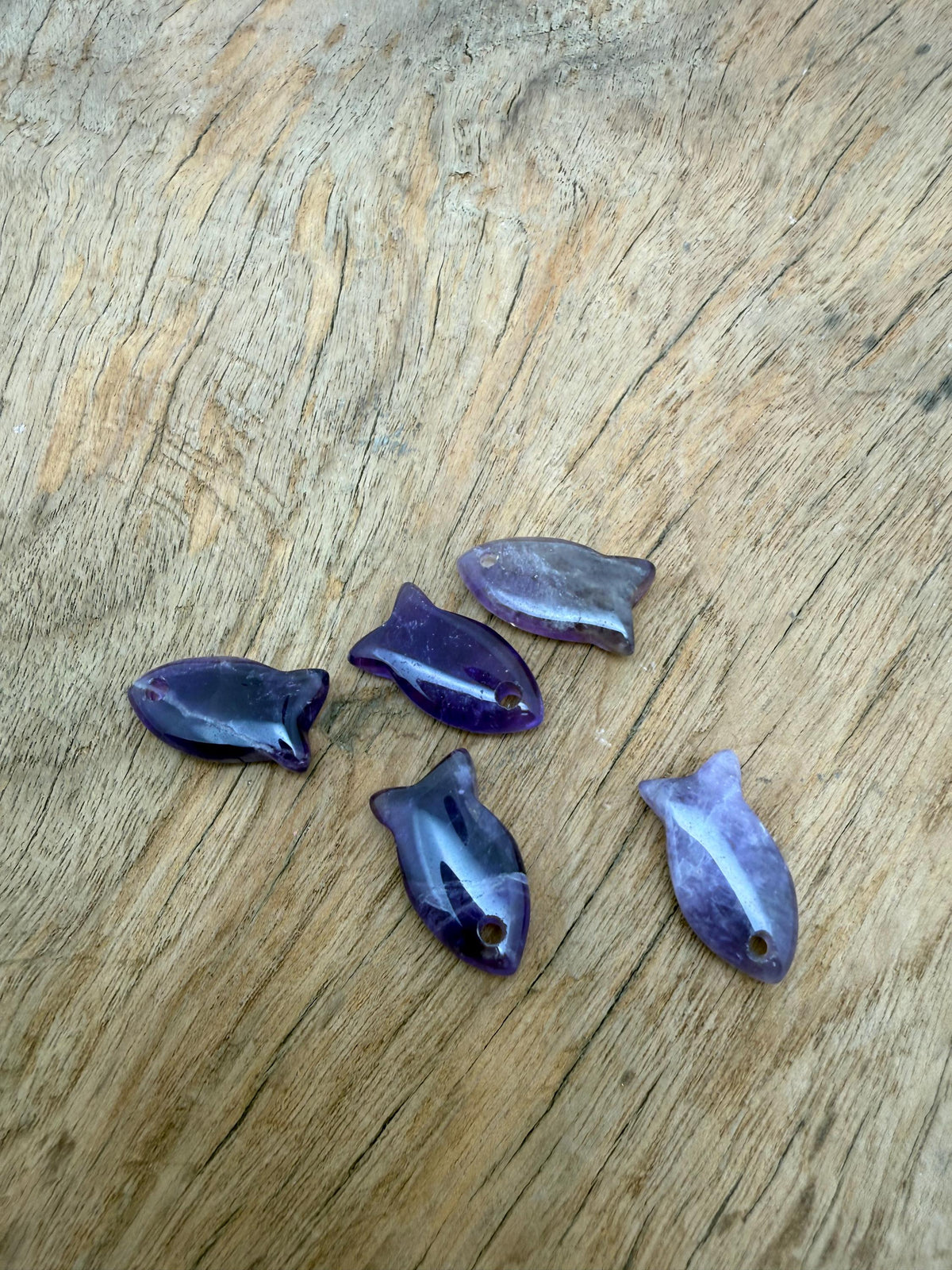 Amethyst fish-shaped crystal pendant with a healing stone design, showcasing a purple gemstone charm for jewelry.
