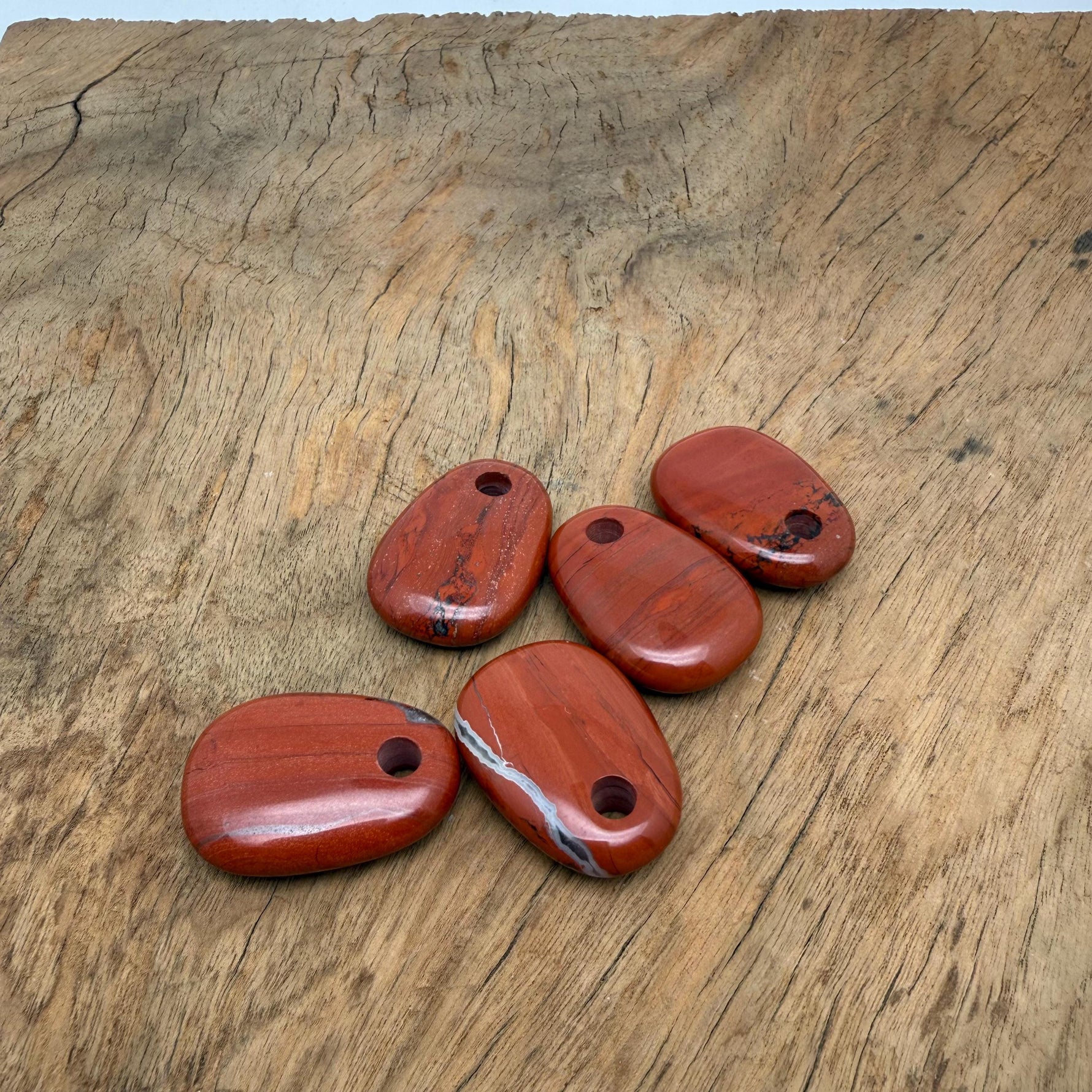Red Jasper oval crystal pendant from GemstoneGO featuring a polished natural stone bead for jewelry making.