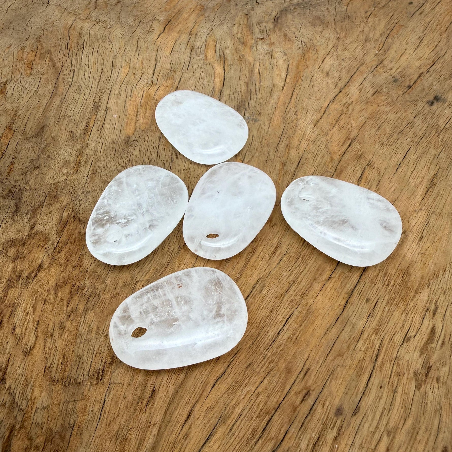 Clear quartz oval crystal pendant from GemstoneGO, natural stone jewelry making bead with polished surface and transparent clarity.