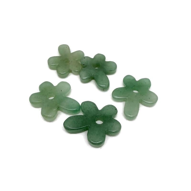 A carved aventurine gemstone flower pendant with a crystal flower charm, featuring intricate details and vibrant green hues.